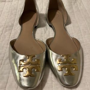 Tory Burch silver flats with gold trademark logo.
